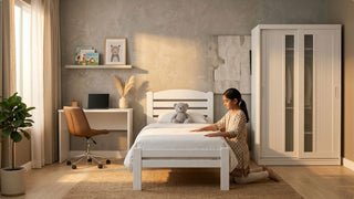 Girl arranging a white single bed in a 3-bedroom condo children’s room with wardrobe and study desk