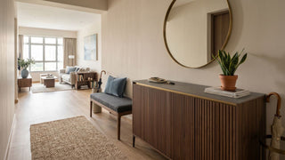 Wooden shoe cabinet with round mirror in a 5-room HDB foyer leading into a bright living room.