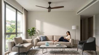 6 feet wooden ceiling fan above a beige sofa in a bright Singapore living room with large windows.