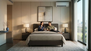 Air con unit above a bed in a modern Singapore condo bedroom with city view
