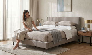 Modern Singapore bedroom with upholstered bed frame, mattress, bedside tables, and natural daylight