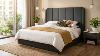 Woman sleeping on a bed mattress in a warm modern Singapore bedroom with grey fabric headboard and balcony plants