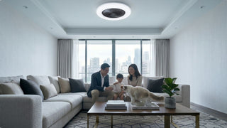 Bladeless ceiling fan in a bright Singapore living room with family, sofa, coffee table and city view