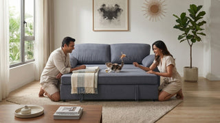 Couple using a blue sofa bed with a kitten in a cosy Singapore living room