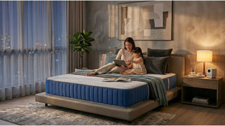 Mother and child relaxing on a blue super single mattress in a cosy Singapore bedroom with warm bedside lighting