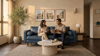 Couple sitting on a blue two seater sofa in a warm modern Singapore home