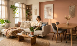 Bohemian HDB living and dining room with beige sofa, jute rug, plants, macrame wall decor and terracotta feature wall.