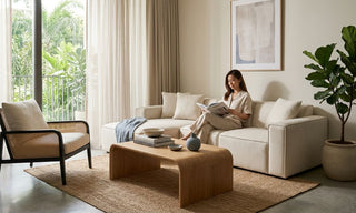 Bohemian Singapore living room with neutral sofa, wood coffee table, cane chair, jute rug, indoor plant, and soft natural light