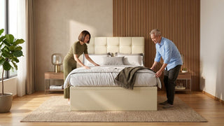 Couple making a bed with a breathable duvet cover in a bright Singapore bedroom with warm wood accents