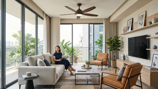 Modern Singapore condo living room with a wooden ceiling fan, natural daylight, balcony greenery, and neutral furniture.