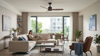 Ceiling fan in a bright Singapore living room with beige sofa, balcony view, dining area, and warm wood accents.