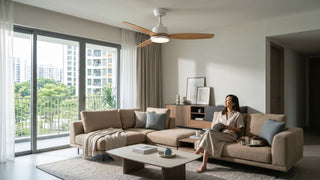 Ceiling fan with light in a bright Singapore condo living room with beige sofa, wooden furniture and pet cat