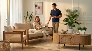 Relaxed coastal living room with cane sofa, matching armchair, wood coffee table and indoor plants