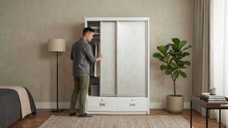 Man organising clothes in a white sliding door wardrobe designed for a compact 1-bedroom condo bedroom