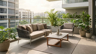 Outdoor sofa set with coffee table and potted plants on a Singapore condo balcony.