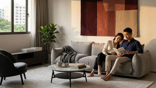 Couple relaxing on a grey velvet sectional sofa in a warm modern living room