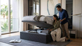 Couple using a hydraulic storage bed frame with deep under-bed compartments in a modern Singapore apartment bedroom