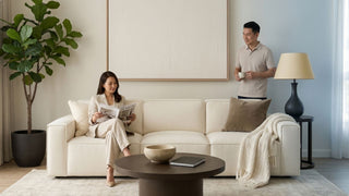Cream Japandi sofa styled with neutral cushions and throw in a bright Singapore living room with coffee table and indoor plant