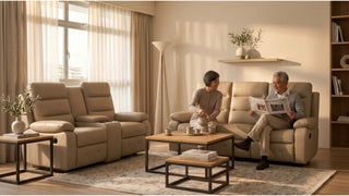Older couple relaxing on cream recliner sofas in a warm Singapore living room with coffee table and soft daylight