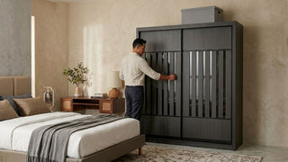 Man opening a dark aluminium wardrobe in a modern Singapore bedroom with neutral styling