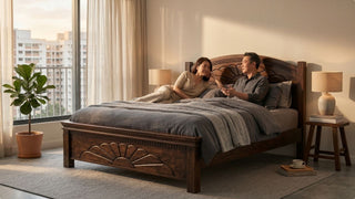 Couple relaxing on a dark custom wood bed frame in a warm Singapore bedroom