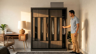 Man checking a dark wood sliding wardrobe in a warm modern 4-room HDB bedroom