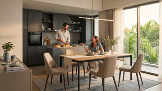 Couple enjoying an open-plan Singapore kitchen and dining area with built-in Europace oven, modern cabinetry, dining table and balcony greenery.