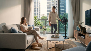 Europace stand fan in a bright Singapore condo living room with a couple, sofa, cats, and balcony view.