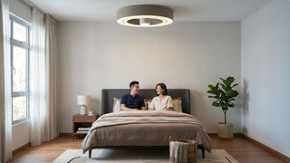 Couple resting under an Exhale bladeless ceiling fan in a calm Singapore bedroom
