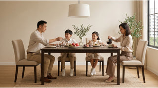 Family enjoying a meal at a dark wood dining table with beige chairs in a cosy Singapore HDB-style home