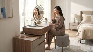 Woman using a round mirror vanity with skincare products in a warm modern Singapore bedroom.