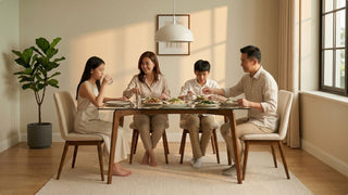 Family dining around a glass dining table with upholstered chairs in a warm modern Singapore home