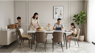 Family using a marble-look dining table in a Singapore home with upholstered chairs and practical storage nearby