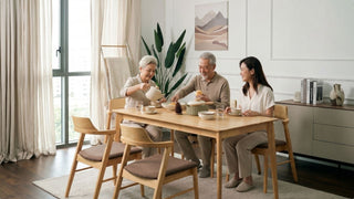 Family sharing a meal at an oak dining table in a modern Singapore dining room