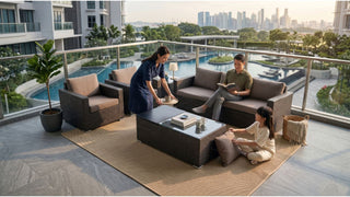Family enjoying a rattan outdoor sofa set on a large Singapore condo balcony with pool and city views