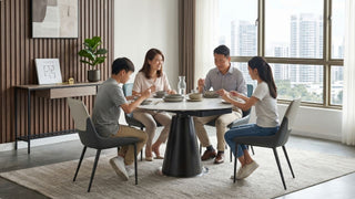Family dining at a round table in a bright Singapore HDB home with modern chairs and compact dining layout
