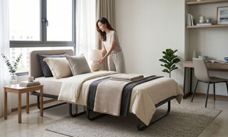 Foldable bed styled in a Singapore spare room with study desk, bedside table, and neutral bedding.