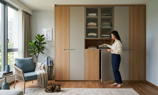 Full height cabinet with wood and grey panels in a Singapore home, showing wardrobe storage and folded clothes.