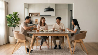 Granite dining table with wooden legs and cushioned chairs in an open-plan Singapore home