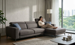 Grey L-shaped gaming sofa with chaise in a bright Singapore living room, showing a comfortable setup for long gaming or lounging sessions.