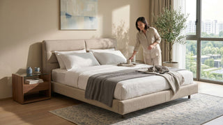 King size upholstered bed in a bright Singapore condo bedroom with bedside table, large windows and comfortable walking clearance.