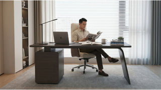 Large solid wood desk with office chair and laptop in a clean Singapore home office setup