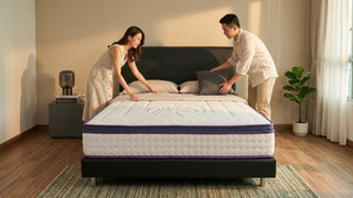 Couple arranging pillows on a latex mattress in a warm modern Singapore bedroom