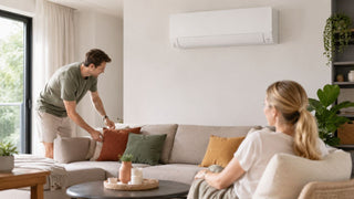 Wall-mounted LG-style aircon above a cosy sofa in a modern Singapore living room styled for everyday comfort.