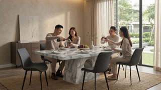 Friends enjoying drinks around a marble 8-seater dining table in a modern Singapore dining area with natural light
