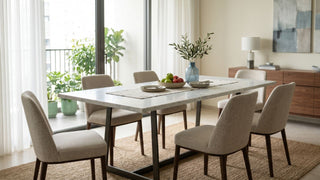 Modern marble dining table with upholstered chairs in a bright Singapore condominium dining area