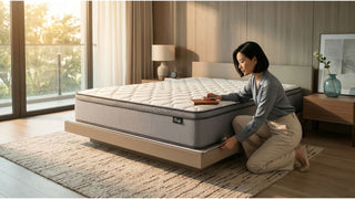 Homeowner measuring bed frame clearance around a mattress in a modern Singapore bedroom