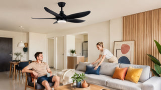 Black Acorn ceiling fan with light in a warm modern Singapore living room styled for everyday family comfort.