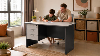 White parent helping a child study at a grey study table in a modern Singapore family home