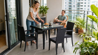 Black wicker balcony table set with glass top styled for morning coffee in a modern Singapore condo balcony